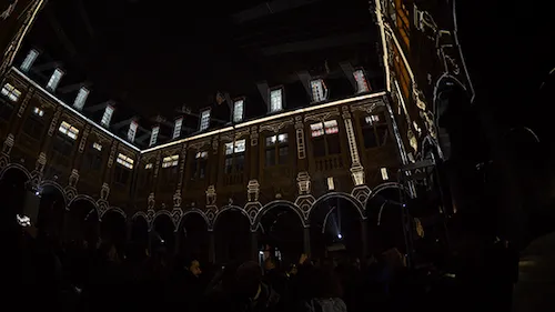 Inside Lille's old stock exchange, a crowd is gathering during a video mapping festival