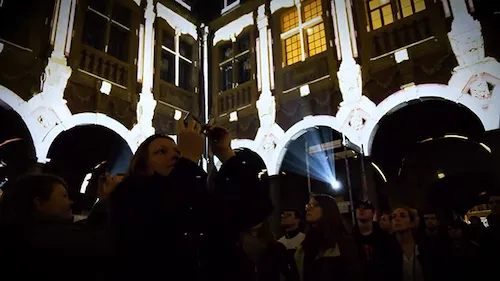 Inside Lille's old stock exchange, a crowd is gathering during a video mapping festival